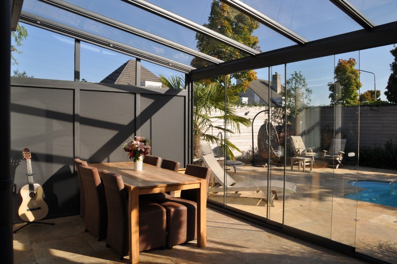 glass outdoor room with partial solid side infill